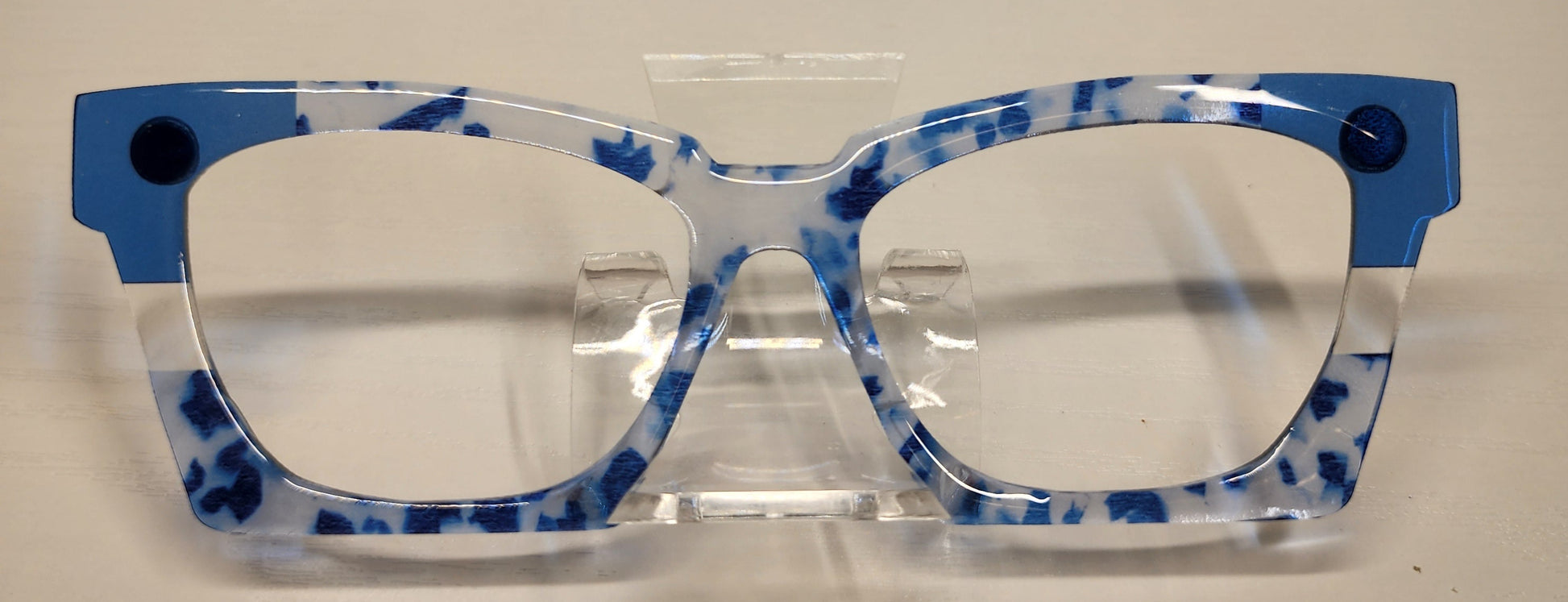 Blue and clear glasses with 'Wanda Case' label against a branded background