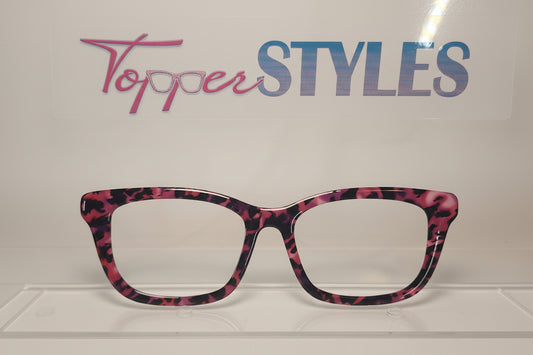 Pink and black patterned eyeglass frame on a white background with 