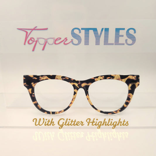 A pair of eyeglasses with a black, brown, and gold tort print frame, displayed vertically against a white background with a vertical brand logo that reads 'Topper Styles'.