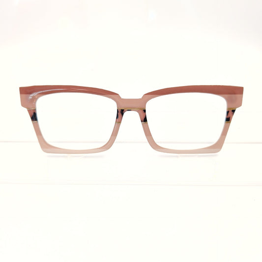 A pair of cat-eye style eyeglasses with a translucent dusty rose pink frame and clear lenses, displayed against a clean white background.